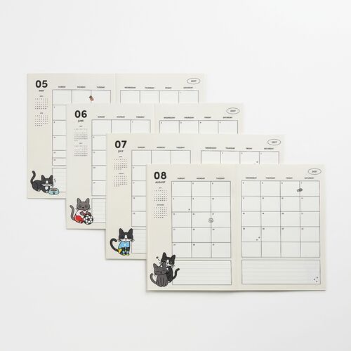 The calendar pages feature adorable black and gray cats in various playful poses, accented with small, colorful illustrations on a clean white background.