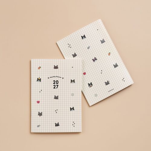 Two Lana & Tuxedo Cat planners with adorable checkered covers featuring playful cat and accessory illustrations, set against a soft beige background.