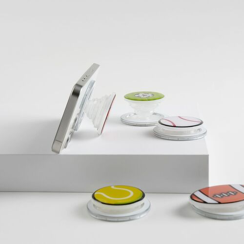 The Seattle Magnetic Phone Grip features a glossy epoxy surface with vibrant, playful designs, shown attached to a phone against a plain background.