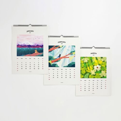 Three Seattle-themed wall calendars for January, February, and March are displayed, each featuring vibrant, illustrative landscapes and clear monthly grids.