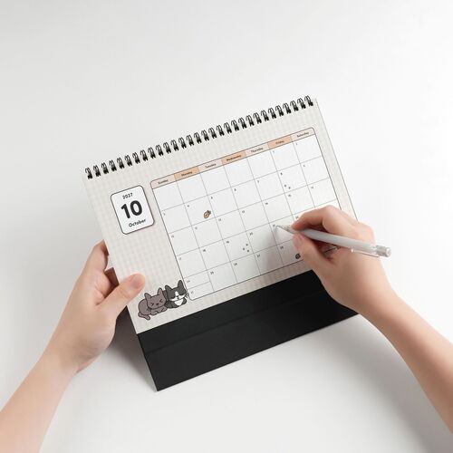 The calendar displays a clean, organized layout with illustrated Lana and Tuxedo cats at the bottom, featuring a modern, minimal aesthetic.