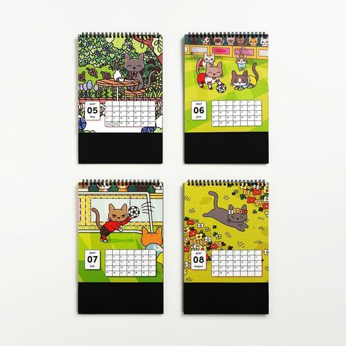 Colorful, playful cat-themed calendar pages featuring vibrant illustrations and bold month labels, arranged in a neat grid on a white background.