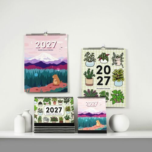 Multiple vibrant 2027 houseplant-themed calendars are displayed on a clean, minimalist shelf, showcasing colorful botanical illustrations and modern design.