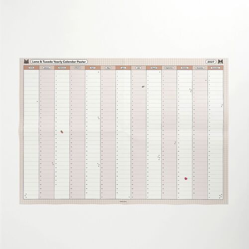 A full front view highlights the tidy grid, monthly labels, small decorative icons, and broad writing areas across the A2 poster.