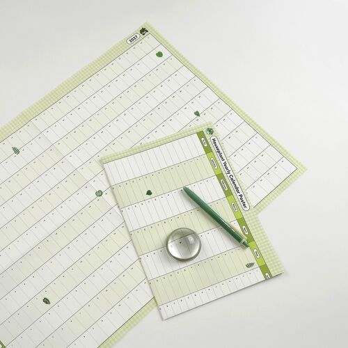 A closer tabletop view shows the Vertical style's stacked months, pale green sections, and scattered houseplant illustrations.