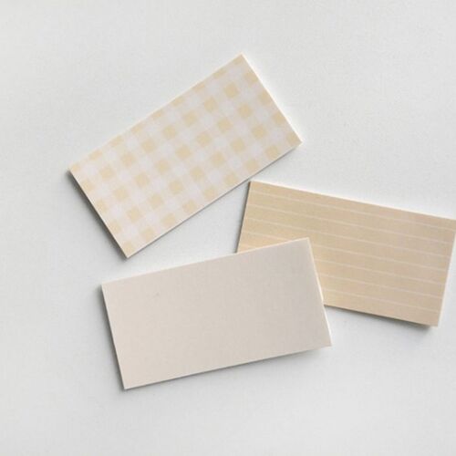 Three beige sticky note sheets with varied patterns—checkered, lined, and plain—are displayed on a white background, highlighting their subtle textures and soft hues.