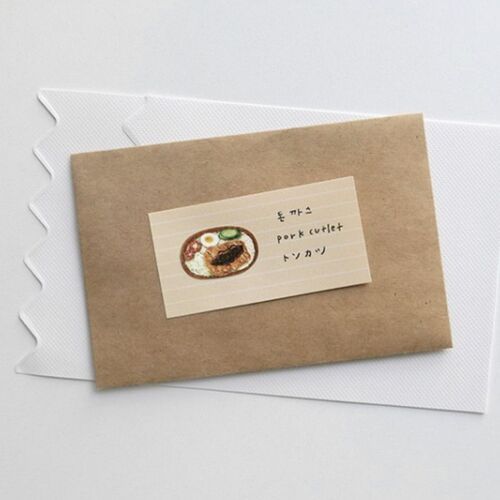 A small, beige sticky note with a colorful illustration and handwritten text, placed atop textured white and transparent sheets, highlighting its playful yet functional design.