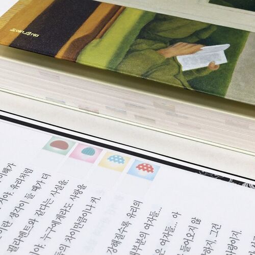 A close-up of a stack of sticky notes featuring soft pastel tones and charming patterns, set against a clean white background.