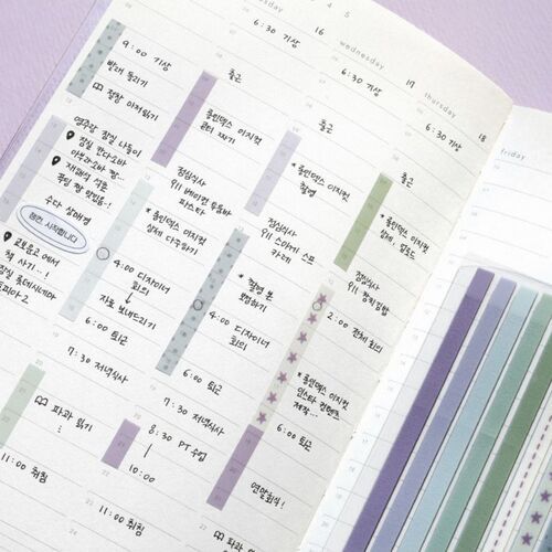 The image showcases colorful, decorative long sticky notes arranged on a planner page, highlighting various appointments and tasks with vibrant patterns.