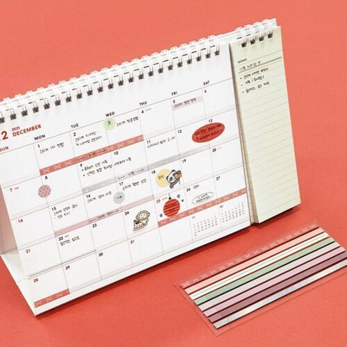 The image features a colorful desk calendar with a set of decorative sticky notes placed beside it, highlighting their vibrant patterns.