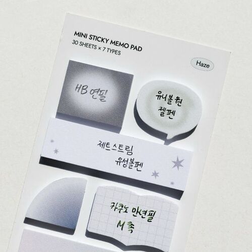 A close-up of the product packaging showcases seven mini sticky note designs with Korean labels, emphasizing their variety and aesthetic appeal.