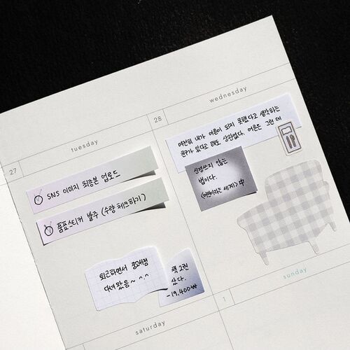 Close-up of a weekly planner page featuring various mini sticky notes with handwritten Korean text, showcasing their diverse shapes and subtle pastel colors.