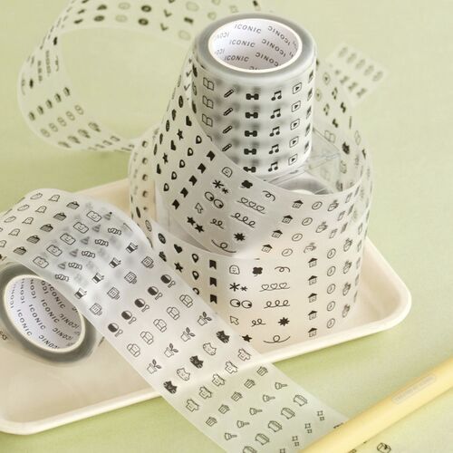A playful display of black-and-white doodle tape rolls with various icons, arranged in a spiral pattern on a pastel green background.