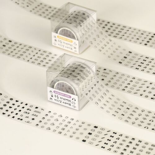 Two clear plastic cases of kiss cut tape with black and white doodle icons, set against a plain white background, showcasing the product's playful design.