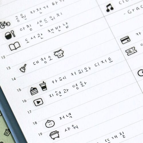 The image showcases a close-up of a white sheet with neatly drawn black icons and Korean text, emphasizing clarity and organized design.