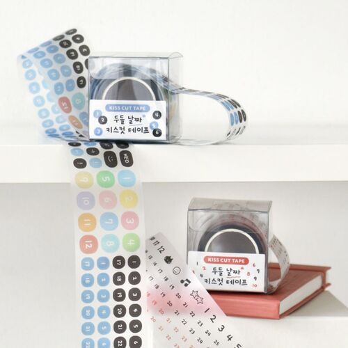 Colorful doodle tape rolls with playful icons and numbers are displayed alongside matching sticker sheets and precise tweezers, creating a cute, organized scene.