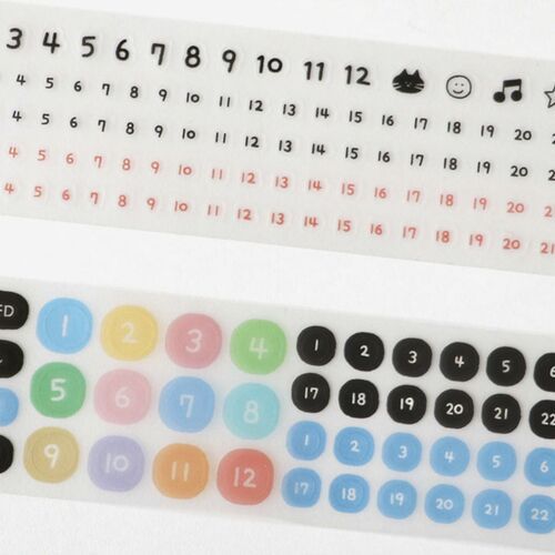 Colorful stickers featuring numbers, days, and icons are neatly arranged on a white sheet, with a playful and cheerful vibe.