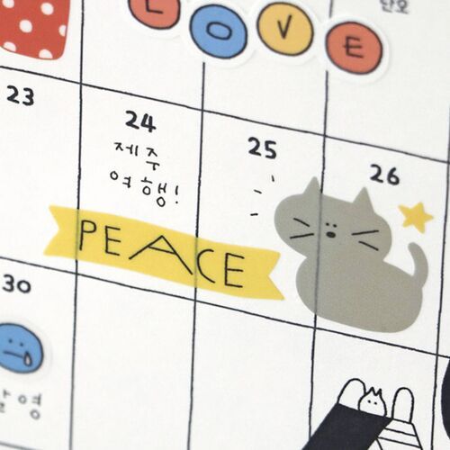 A close-up of a colorful calendar page featuring adorable doodle stickers, including a cute gray cat and the word 'PEACE' highlighted in yellow.