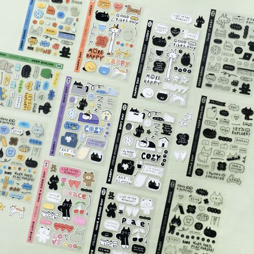 A colorful assortment of six sticker sheets features playful doodle designs of cats, bears, and icons in vibrant and monochrome styles.