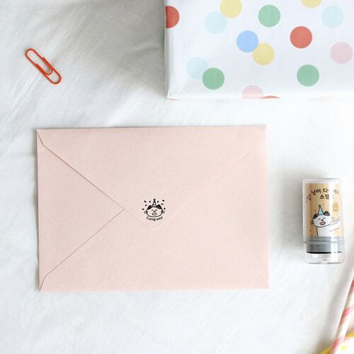 A cute pink envelope with a cat sticker, a colorful polka-dot gift box, and a self-inking stamp featuring a cheerful cat illustration on a clear background.