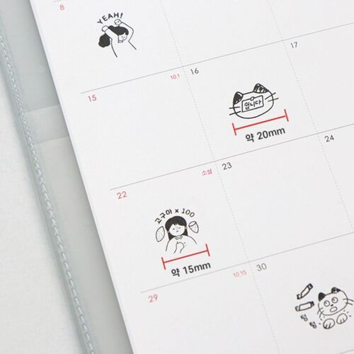 A close-up of the calendar page showcasing adorable black and white doodles, including a girl with a speech bubble and a cat, with red measurement lines highlighting stamp size.