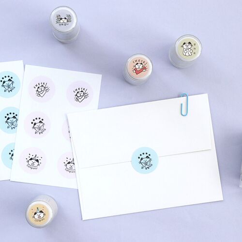 The image showcases a collection of cute, cat-themed self-inking stamps with colorful, playful illustrations, accompanied by matching sticker sheets and a white envelope.