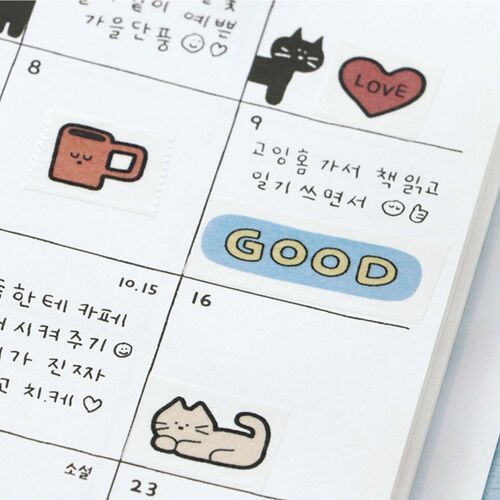 A close-up of a calendar page featuring colorful doodle stickers, including a cute coffee mug, a playful cat, and cheerful text, adding charm to the layout.
