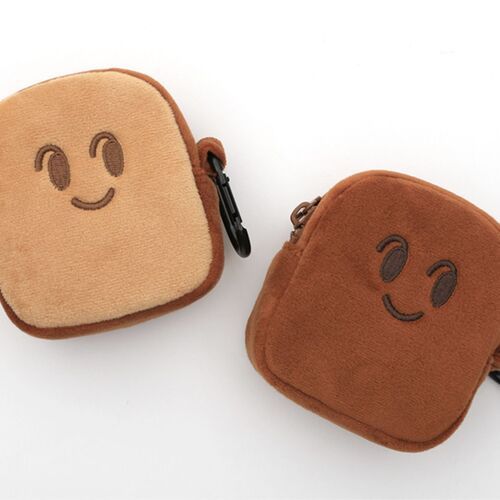 Two plush mini toast pouches in light and brown shades feature smiling faces, attached to black metal rings against a white background.