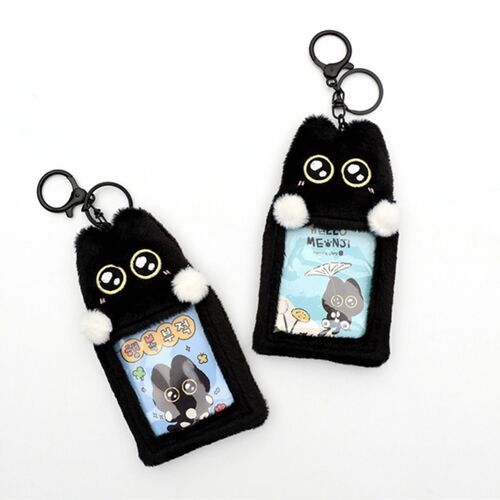 Two black cat plush photocard key rings with expressive eyes and white pom-pom accents, displayed against a plain white background.