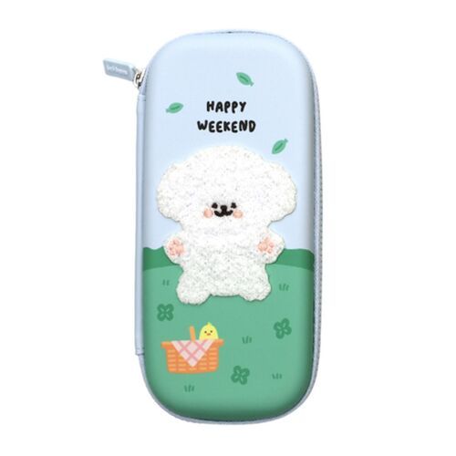 The pen case features a playful design with a fluffy white plush dog, surrounded by green leaves and a basket, set against a pastel blue background.