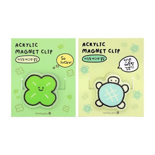 Two acrylic magnet clips featuring cheerful green clover and adorable turtle designs, set against pastel green backgrounds with playful doodles.