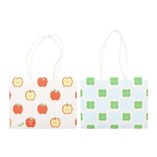 Two small gift bags with colorful apple and clover patterns, featuring white die-cut handles and vibrant, playful designs on a white background.