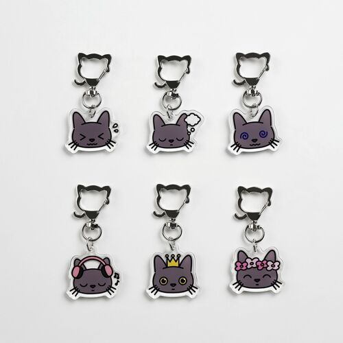 Six Lana Cat emoji acrylic key rings are arranged on a white surface, showcasing various expressive faces and playful accessories.