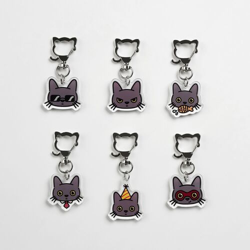Six Lana Cat emoji acrylic key rings with playful faces, each featuring unique expressions and accessories, arranged in two rows on a white background.