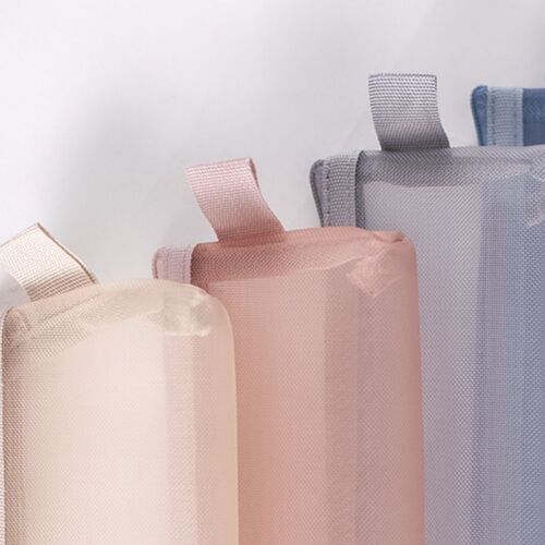 Three Soft Mist Mesh Pen Pouches in pastel shades—peach, gray, and blue—arranged diagonally against a plain white background, highlighting their colors and textures.