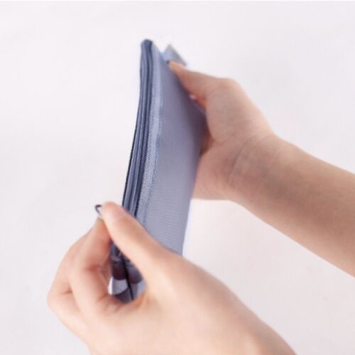 A hand gently holds the light blue mesh pen pouch, showcasing its slim profile and smooth zipper against a plain white background.