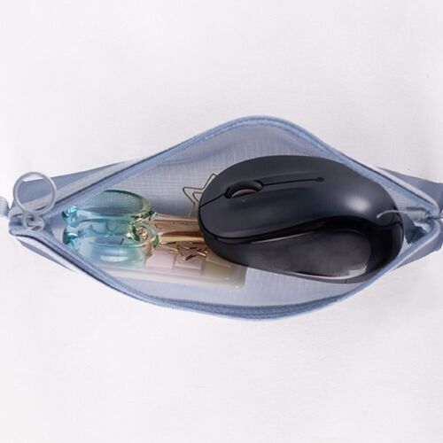 A light blue mesh pouch unzipped on a white surface reveals a black computer mouse, gold paper clips, and transparent scissors inside.