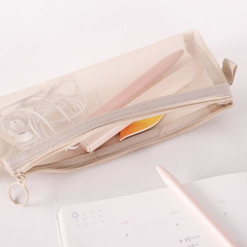 The mesh pouch in soft blush pink with a transparent front reveals neatly organized earbuds and a small notebook inside.