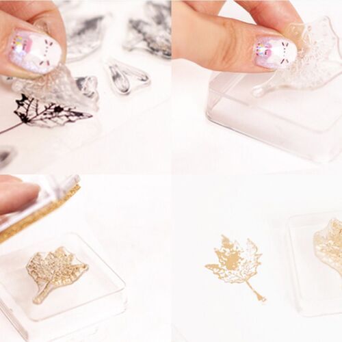 Showcases the metallic shimmer stamp pad's gold finish being peeled from its protective layer, highlighting its intricate leaf design and glossy surface.