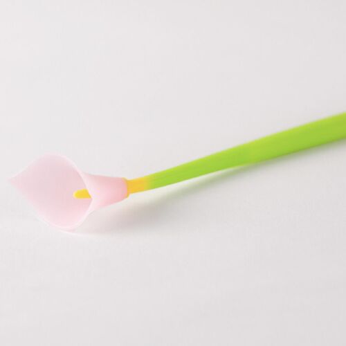A delicate pink calla lily flower with a soft, matte finish, connected to a vibrant green stem, set against a plain white background.