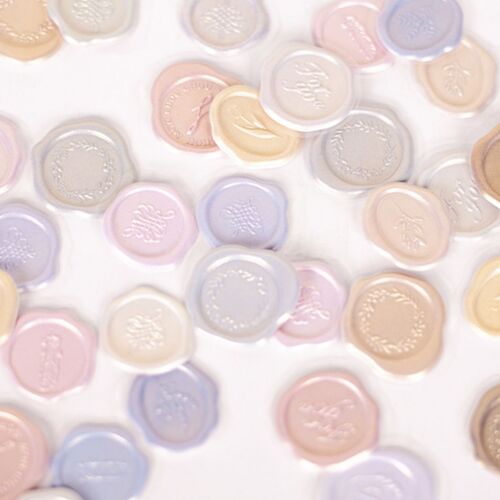 A colorful assortment of 18 self-adhesive sealing wax stickers in pastel shades with embossed floral and word designs, arranged on a white surface.