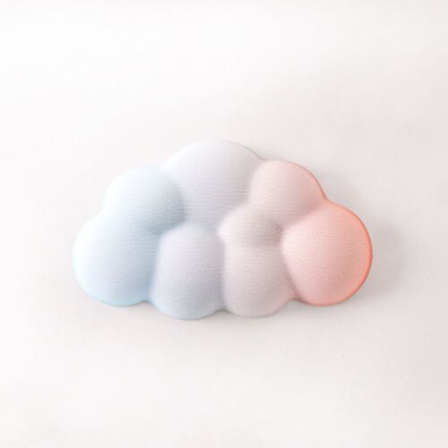 A pastel-colored cloud-shaped cushion with a soft gradient blending light blue, pink, and white hues, resting on a white surface.