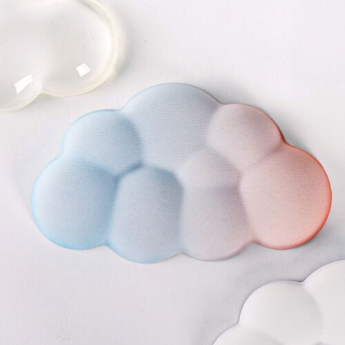 A pastel-colored cloud-shaped wrist cushion with a soft, textured surface in a calming gradient of blue, pink, and white hues.