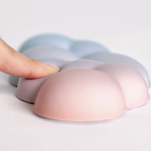 A pastel gradient sunset cloud wrist cushion with a plush, textured surface, positioned on a clean, white background, emphasizing its soft look.