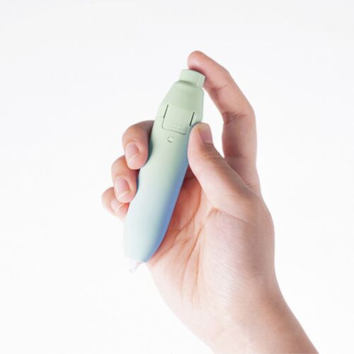 A hand holds the pastel gradient Daylight Cloud correction tape, showcasing its compact design and smooth, ergonomic shape against a plain white background.