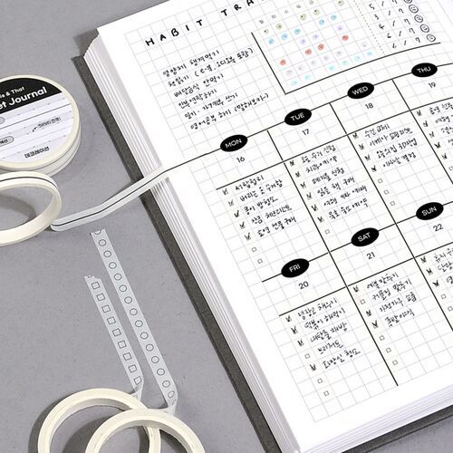 A completed habit-tracking page pairs checkbox and circle strips with a monthly grid and handwritten entries.