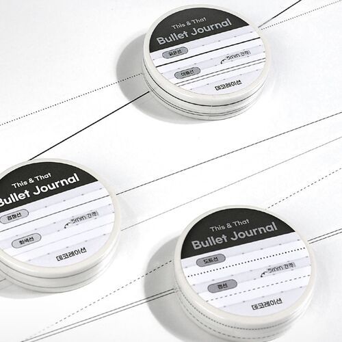 Several labeled rolls sit on an open notebook, showing how the tracker tape coordinates with structured journal pages.
