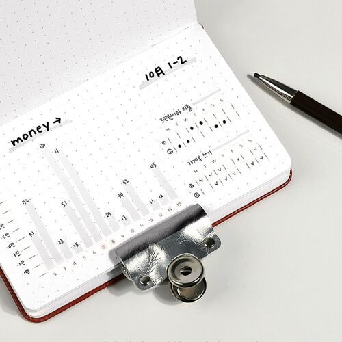 The tape appears beside a handwritten planning page, where its slim format supports organized notes and tracking.