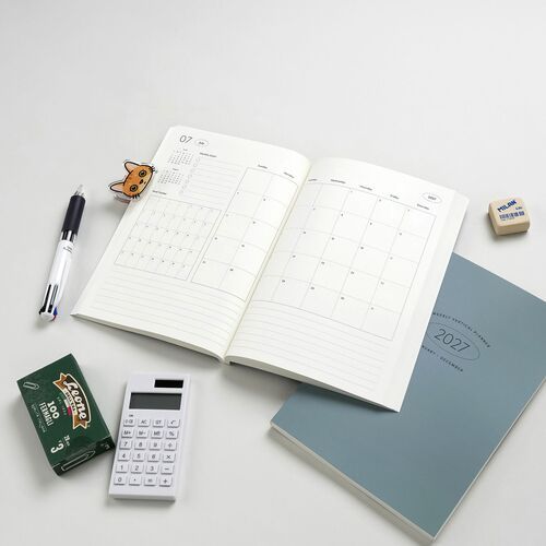 Open weekly planner displaying clean, minimalistic layouts with visible grid lines, set against a plain, light background for clarity.
