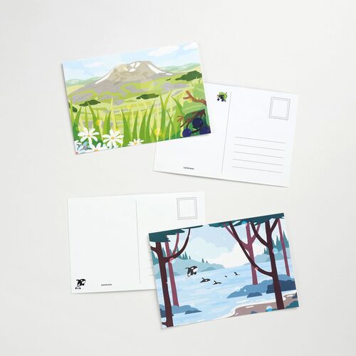 Mountain and blossom artwork is displayed with the postcard backs, showing open space for personal messages and addresses.
